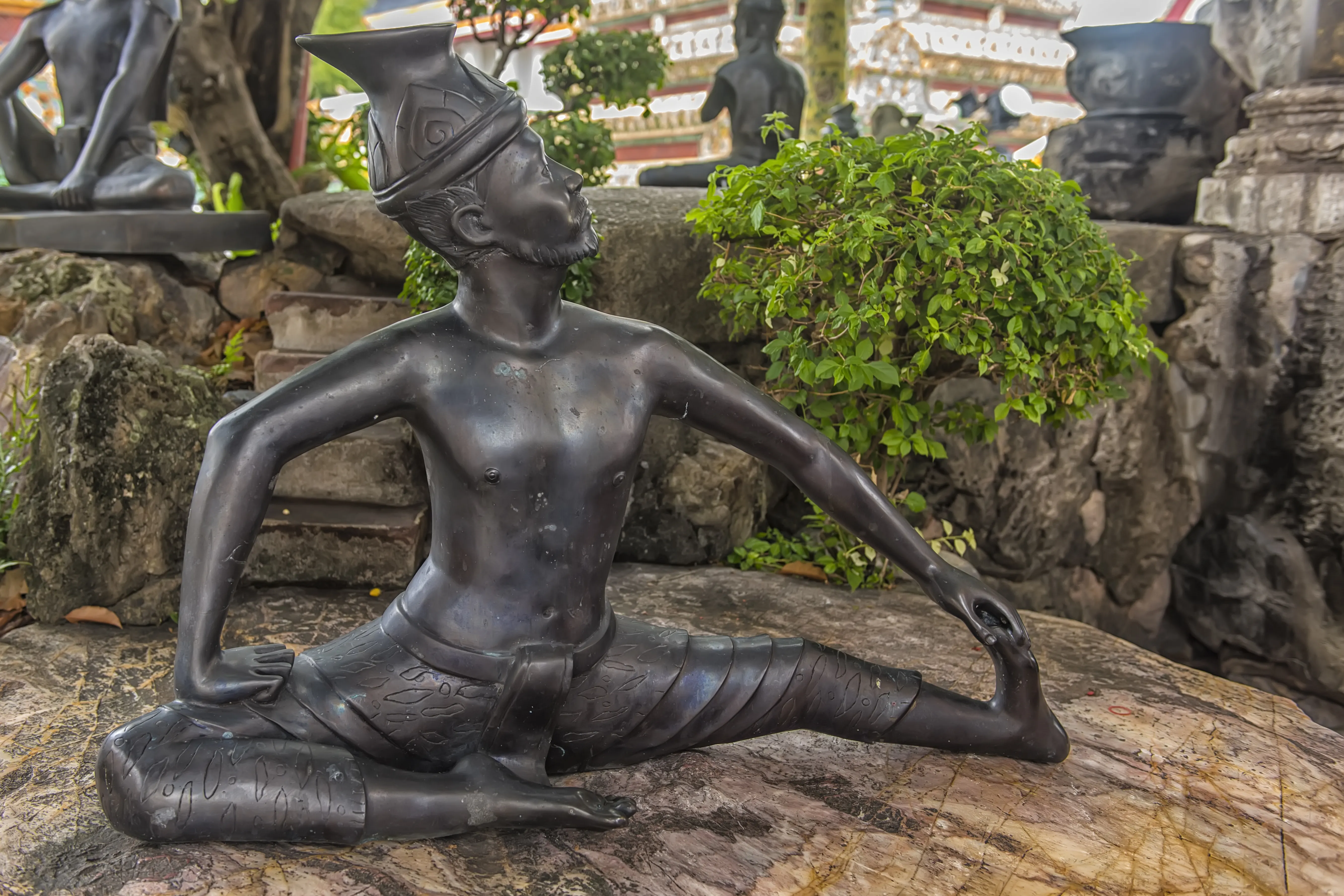 ancient statue of Thai massage pose